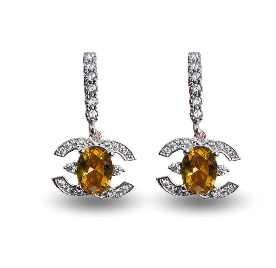 Earrings with oval-shaped Zultanite and a geometric zircon-studded frame.